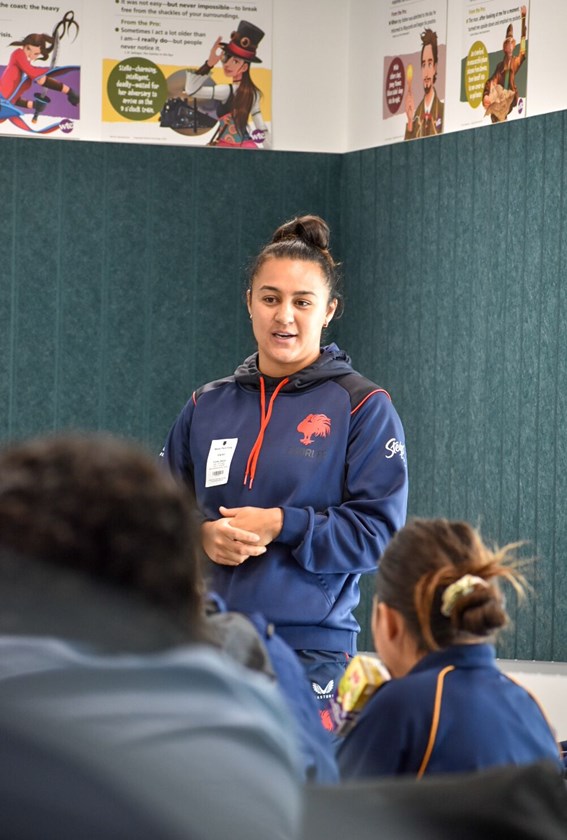 Roosters NRLW Premiership-winner Corban Baxter addresses the Mabel Park SHS female programme before a training session.