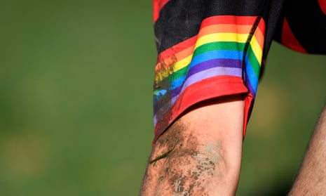 A rugby player wears a rainbow armband