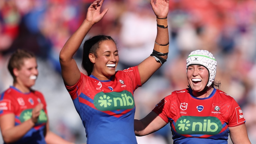 A woman celebrates winning a rugby league match