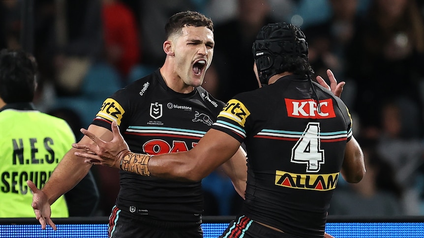 Two men celebrate a try in a rugby league match