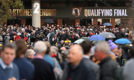 Fans queue to enter the MCG during the AFL qualifying final between Collingwood Magpies and Melbourne Demons