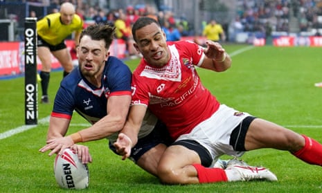 Matty Ashton scores England’s second try despite the efforts of Tonga's Will Hopoate.