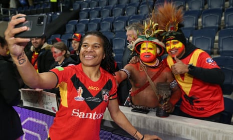 Papua New Guinea Orchids player Roswita Kapo takes a selfie with fans after a match