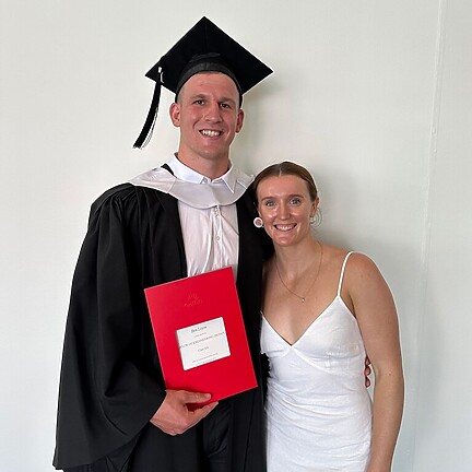 Liyou alongside his partner Zali Webb after graduating.