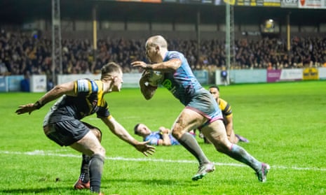 Wigan’s Liam Marshall evades Castleford defenders to score a try.