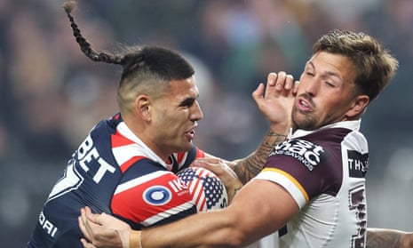 Terrell May of the Roosters is tackled by the Broncos’ Tyson Smoothy during the NRL game at Allegiant Stadium in Las Vegas.