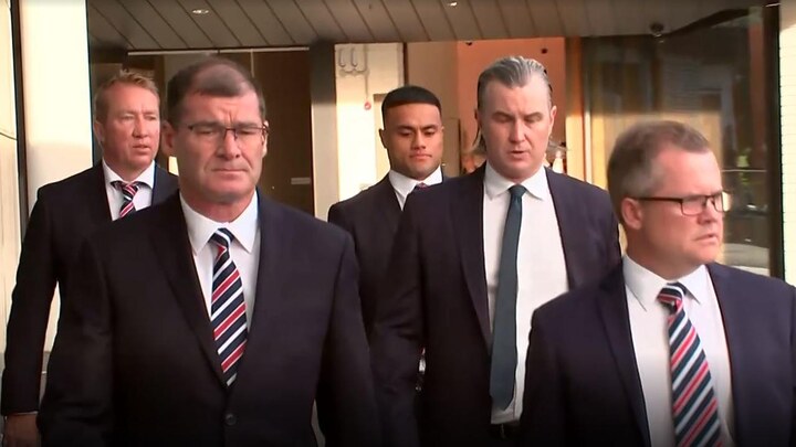 Roosters coach Trent Robinson (left) and Spencer Leniu (centre) arrive at NRL headquarters. Photo: Fox League