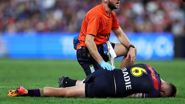 Cameron Munster is tended to by a trainer. (Photo by Hannah Peters/Getty Images)