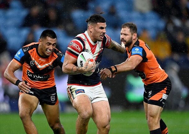 Terrell May charges through the Wests Tigers defensive line in Sunday's victory.