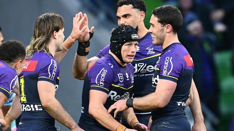 Harry Grant celebrates one of his three tries against Cronulla with teammates. Picture: Quinn Rooney/Getty Images