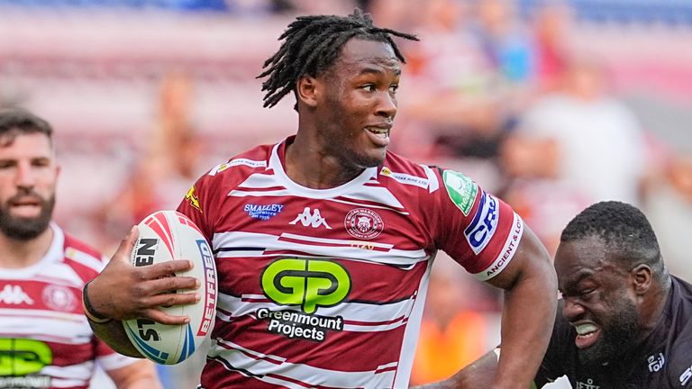 Picture by Olly Hassell/SWpix.com - 21/06/2024 - Rugby League - Betfred Super League Round 15 - Wigan Warriors v London Broncos - DW Stadium, Wigan, England - Junior Nsemba of Wigan is tackled by Sadiq Adebiyi of London