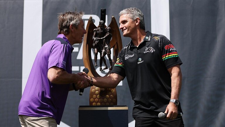 SYDNEY, AUSTRALIA - OCTOBER 03: Craig Bellamy, coach of the Storm and Ivan Cleary, coach of the Panthers shake hands alongside the Provan-Summons Trophy during NRL Grand Final Fan Fest at Overseas Passenger Terminal, on October 03, 2024, in Sydney, Australia. (Photo by Brendon Thorne/Getty Images)