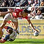 Tolu Koula dives over for a try for Tonga against England in 2023