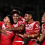 Tonga celebrates during its stunning upset over New Zealand in Auckland. (Photo by Hannah Peters/Getty Images)