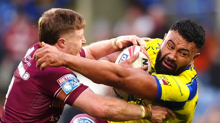 Warrington Wolves' Zane Musgrove (right) tackled by Huddersfield Giants' Zac Woolford during their 20-12 victory on Sunday