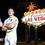 Wigan Warriors captain Liam Farrell and Warrington Wolves captain George Williams stand beside the Welcome to Fabulous Las Vegas sign