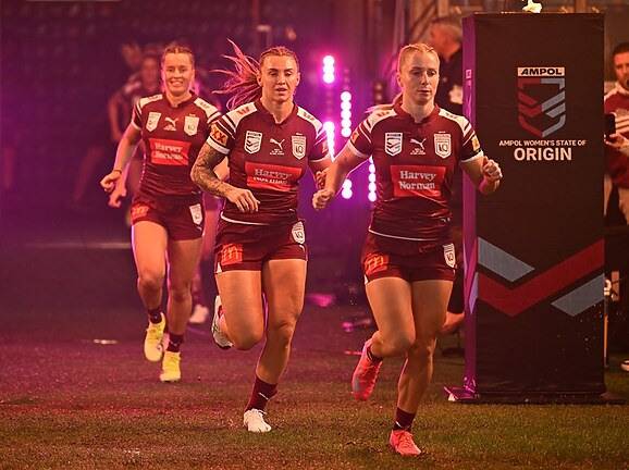Tarryn Aiken runs out for Queensland with Julia Robinson and Lauren Brown.