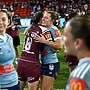 Hannaway (18th player) embraces Sharks teammate Emma Verran after game one of the women's State of Origin series.