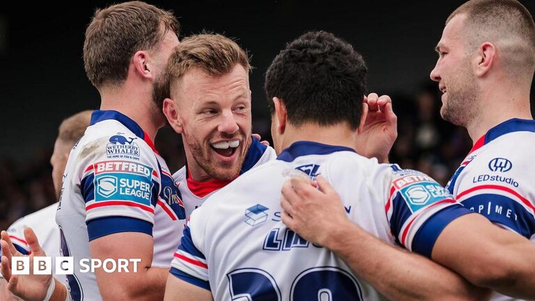 Tom Johnstone celebrates try with half back Mason Lino and team-mates