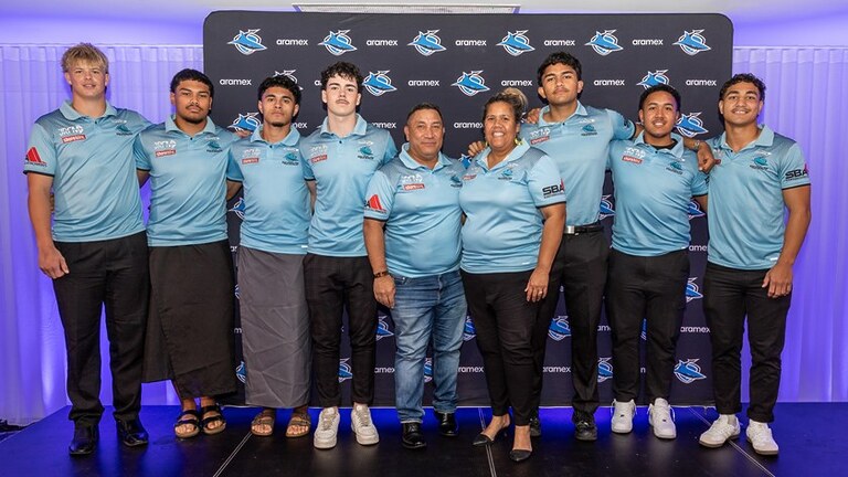 Renee Tatana and husband Kent (centre) with some of Cronulla's Junior Representative players.