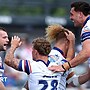 Wakefield Trinity player Max Jowitt (left) is congratulated on his try against Salford City Reds with teammates.