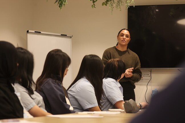 Head of Consumer Georgia Ravics speaks to students from Kingsgrove North High School, sharing her experiences as a rugby league player.