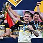 Liam Harris lifting the 1895 Cup alongside team-mates