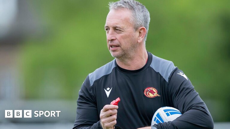 Former Catalans Dragons head coach Steve McNamara holding a rugby league ball and a whistle
