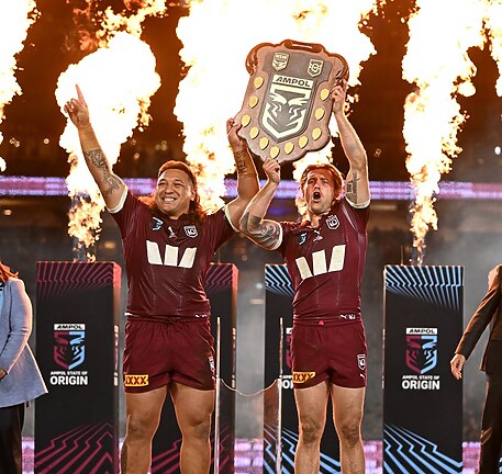 Josh Papalii holds up the State of Origin Shield with Maroons captain Cameron Munster after answering an SOS to play in the series decider