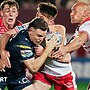 Hull KR winger Tom Davies has the ball in his left arm as he tries to ride the tackles of Jordy Crowther and Sam Powell for Warrington in the 2025 Challenge Cup final.