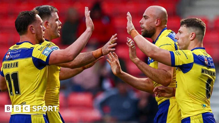 Warrington players celebrate a try by James Harrison (second right)