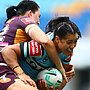 A woman runs the ball during a rugby league match
