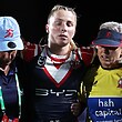 Tarryn Aiken is helped from the field with a knee injury by two Sydney Roosters trainers during an NRLW game.