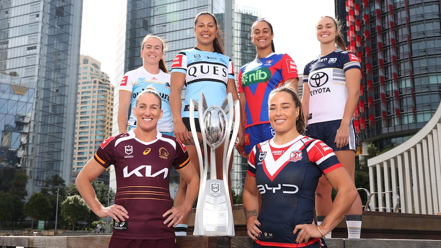 Six NRLW captains pose for a photo with the premiership trophy.