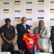 PNGRFL chairman PNGRFL chairman Sandis Tsaka and Visa's Anthony Watson show the Kumuls jersey with the Visa logo on the sleeve.