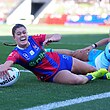 Keighley Simpson scores a try for the Knights in their NRLW final against the Titans.
