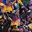 Brisbane Broncos fans at Canberra Stadium cheering and waving flags