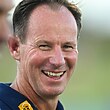 NRL coach Justin Holbrook looking over his shoulder and smiling