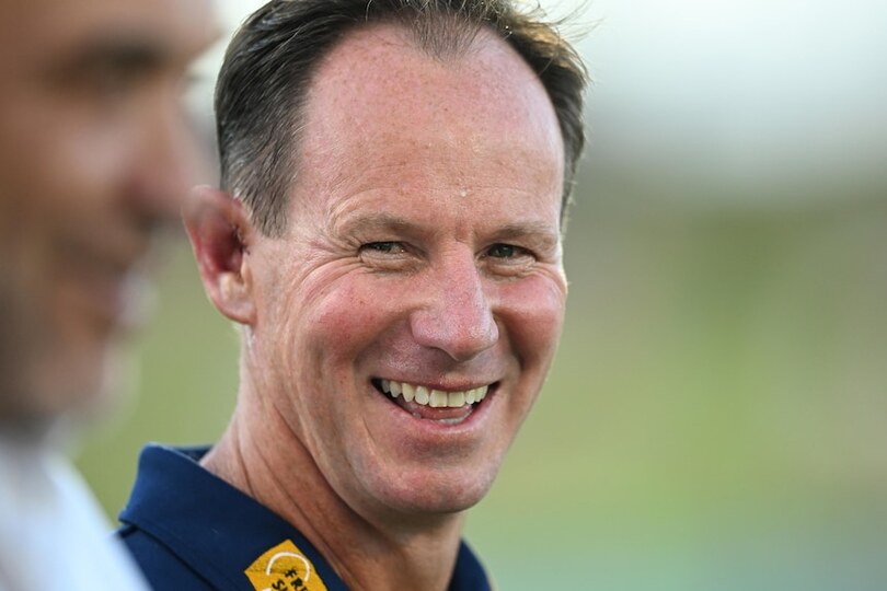 NRL coach Justin Holbrook looking over his shoulder and smiling