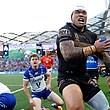 A man celebrates after scoring a try