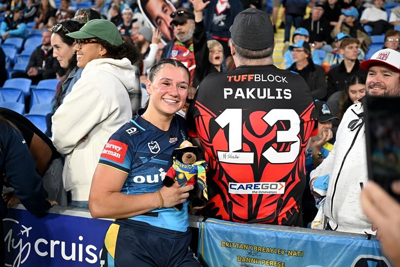 Megan Pakulis with a fan after making her NRLW debut for the Gold Coast Titans.