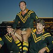 Wally Lewis is chaired from the field by Wayne Pearce and Gene Miles.