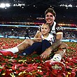 Reece Walsh and daughter Leila celebrates Brisbane's grand final win over the Storm.