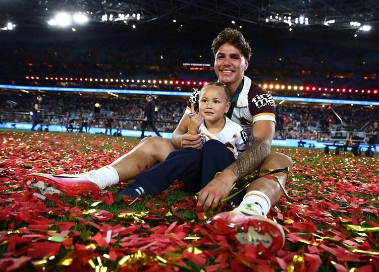Reece Walsh and daughter Leila celebrates Brisbane's grand final win over the Storm.