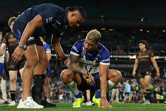Stephen Crichton consoles Viliame Kikau after the Bulldogs’ semi-final loss to Penrith in 2025.