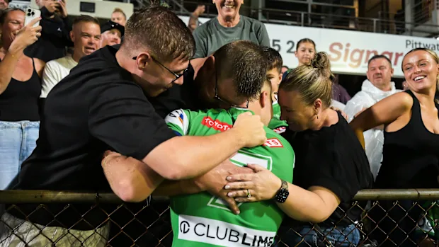 Ethan Sanders embraces his family at 4 Pines Park on Saturday night.