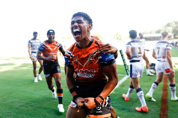 Tigers winger Luke Laulilii scores against the Cowboys.