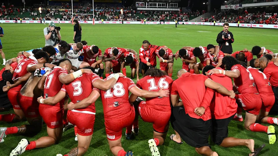Tonga players praying.